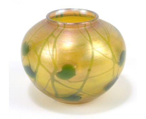 LOUIS COMFORT TIFFANY (1848-1933); a favrile glass vase of bulbous form, with green trailing floral decoration on a yellow gr