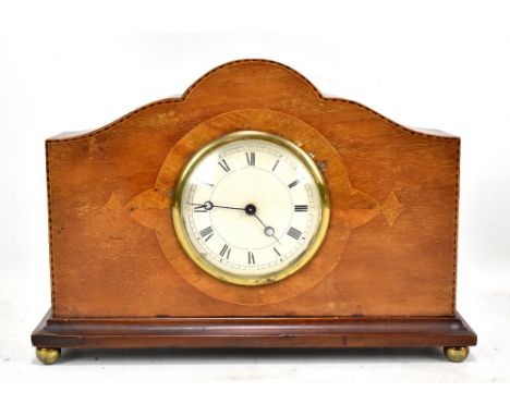 An early 20th century mahogany and inlaid mantel clock, the circular dial set with Roman and Arabic numerals, with Swiss move