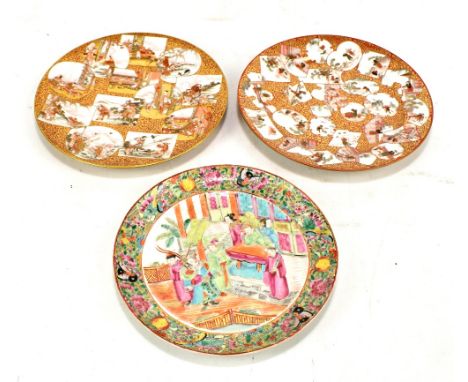 A near pair of late 19th/early 20th century Japanese Kutani ware plates with panelled decoration featuring figures, flora and