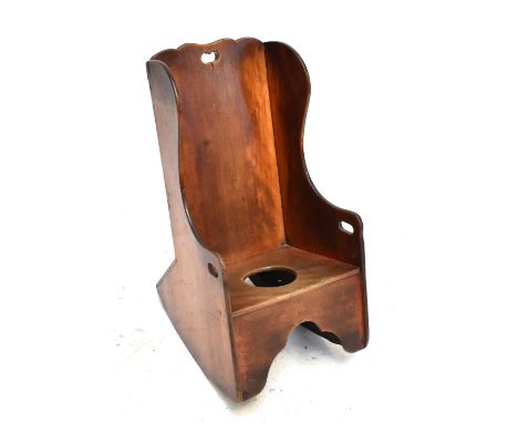 A late 19th century child's mahogany wing back rocking commode chair.