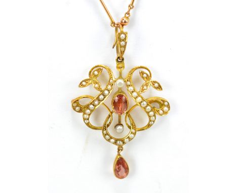 An Edwardian 15ct yellow gold Art Nouveau openwork pendant set with oval cut pink or light orange coloured stone and cultured