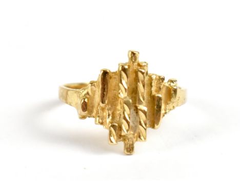 A yellow metal textured abstract ring, stamped to inner band 10K, size P/Q, approx 2.9g.