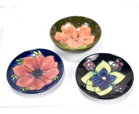 MOORCROFT; a tubeline decorated 'Hibiscus' pattern bowl on green ground, diameter 11.3cm, and two small dishes including 'Ane