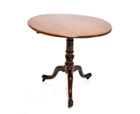 A George III mahogany tilt top tripod table on castors, diameter 79cm.