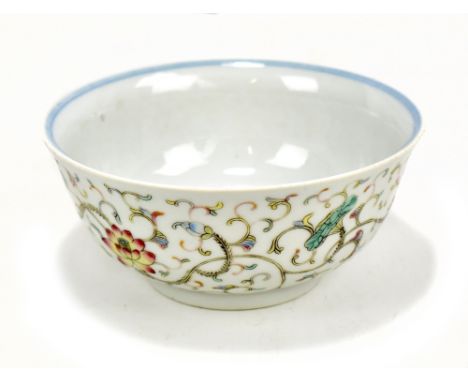 A Chinese porcelain bowl decorated with lotus sprays in polychrome enamels to exterior and with further underglaze blue flora