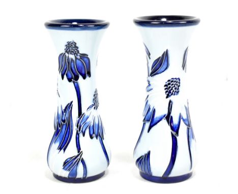 MOORCROFT; a small pair of Florian-type floral tubeline decorated waisted vases with impressed marks and year ciphers for 200