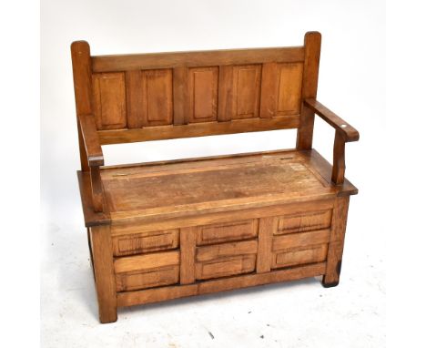 An oak hall bench with hinged seat, width 105cm.