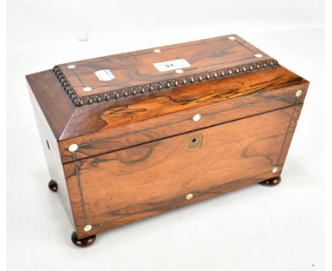 A 19th century rosewood sarcophagus tea caddy, the hinged cover enclosing compartment for a mixing bowl and two lidded compar