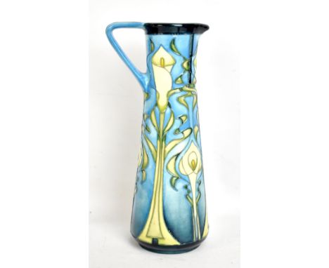 MOORCROFT; a tapered jug with Art Nouveau-style floral tubeline decoration on light blue ground, WM monogram and impressed ma
