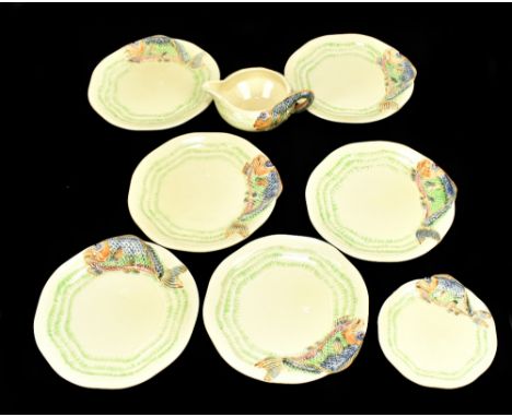 CLARICE CLIFF; an eight piece part table service, each decorated in relief with stylised fish, comprising six sandwich plates