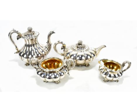 A silver plated four piece tea service having panelled decoration with cast outswept feet. 