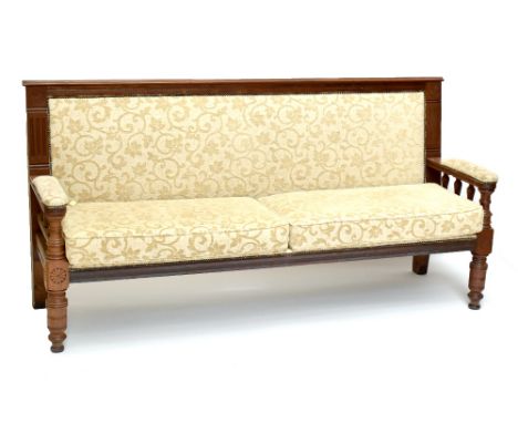 A late 19th/early 20th century walnut framed sofa of typical form, later upholstered in a floral cream material, length 203.5