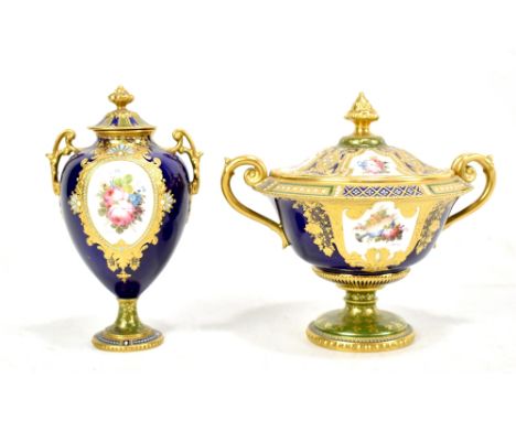 DESIRE LEROY for ROYAL CROWN DERBY; a twin handled pedestal urn vase and cover, with hand painted panels depicting floral spr