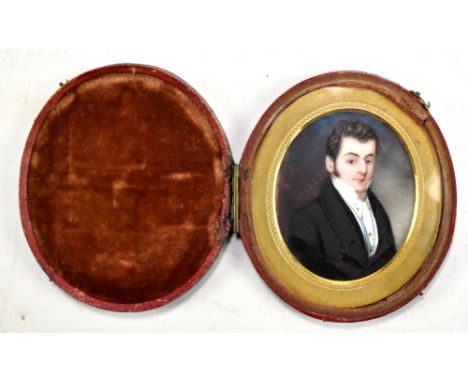 A 19th century English school oval portrait miniature, study of a gentleman, possibly on a printed base in period leather fol