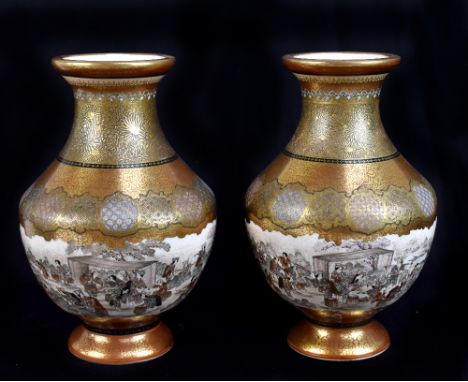 A pair of Satsuma vases, the neck and upper section heavily gilded and decorated with floral sprays above a continuous landsc