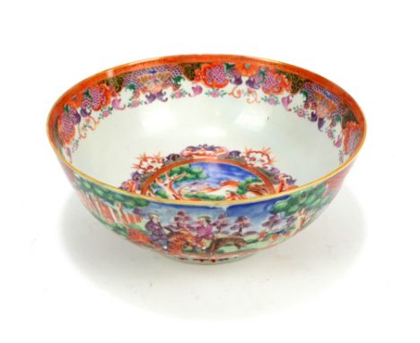 A Chinese inspired fruit bowl decorated with a fox hunting scene with fox hiding in the tree within a floral decorated border