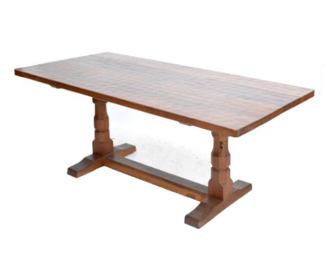 ROBERT&nbsp; 'MOUSEMAN' THOMPSON; an oak refectory dining table with adzed decoration to the top and raised on octagonal colu