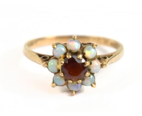 A 9ct yellow gold opal and red stone floral cluster ring, size O/P, approx 2.2g.