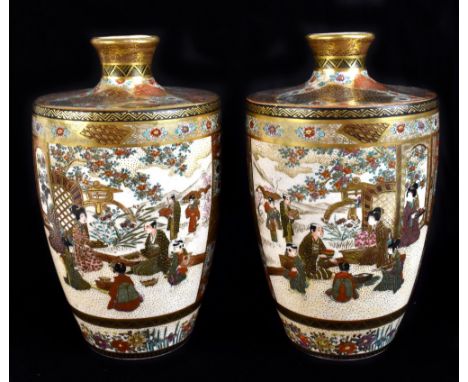 TAIZAN; a pair of Japanese Satsuma vases decorated with opposing panels of figures in a landscape interspersed by abstract fl