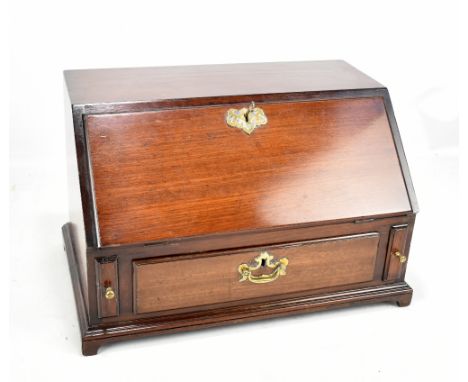 A reproduction mahogany apprentice bureau, the fall-front enclosing fitted interior and drawers, raised on bracket supports, 