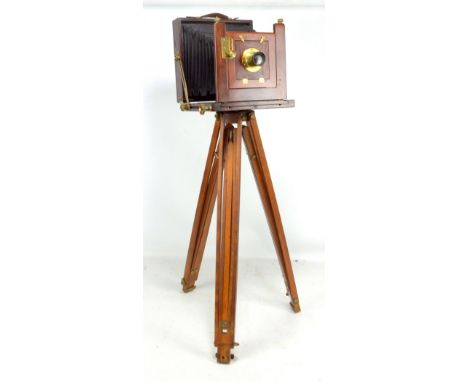 BARNETT &amp; CO OF JOHANNESBURG; a brass bound mahogany cased field camera with manufacturer's plaque to front on tripod sta
