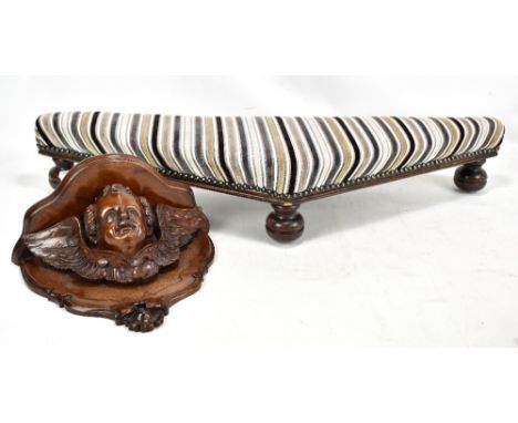 A Victorian carved mahogany wall bracket, with central decoration of a cherub's head and wings, with an early 20th century oa