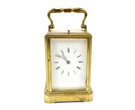 A 19th century brass cased French repeating carriage clock of typical form, the white enamel dial set with Roman numerals, he