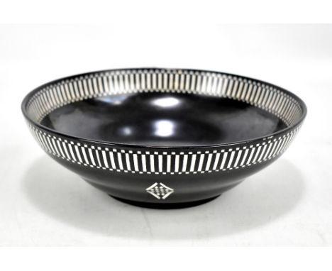 ROYAL WORCESTER; a pedestal bowl, having painted geometric diamond decoration below a chequered rim, factory marks and date c