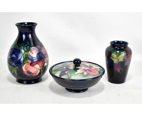 MOORCROFT; an 'Orchid' pattern lidded powder bowl of circular form, diameter 16cm, an 'Anemone' vase of baluster form, blue s