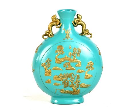 A 20th century turquoise ground gilt heightened moon flask decorated with typical landscape features in relief, with twin han