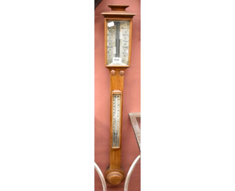 An early 20th century barometer and thermometer inscribed 'Loftus London', length 96cm.