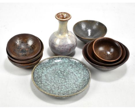 Seven Chinese earthenware Song-type black glazed bowls, diameter of largest 11.2cm, a small jun-type vase, height 11cm and a 