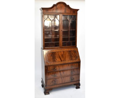 A mid-20th century mahogany bureau bookcase, the upper section having two astragal glazed doors above fall-front and three lo