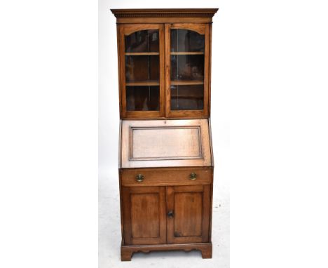 An early 20th Century oak bureau bookcase, with two glazed doors above fall front, raised on bracket feet, height 188.5cm