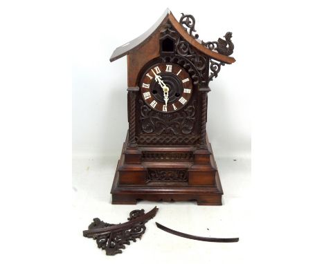 A late 19th century Black Forest cuckoo clock for restoration, the circular dial set with Roman numerals, the front featuring
