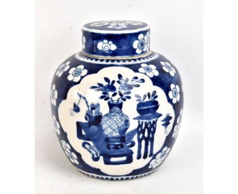 An early 20th century Chinese blue and white ginger jar and cover, painted with panels depicting objects, bears Kangxi double