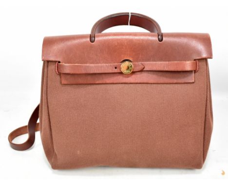 HERMÈS; a 'Herbag Ado PM' two in one maroon red leather and coated canvas backpack, shoulder or handle bag (two bags in one),