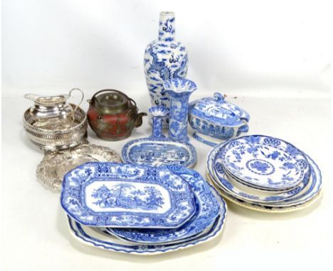 A group of blue and white transfer decorated plates and dishes, a Chinese earthenware teapot and three plated items (several 