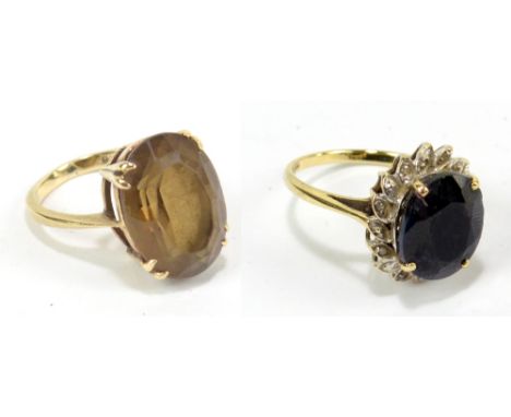 A 9ct yellow gold ring set with large oval cut yellow coloured stone, size K 1/2, and another set with dark blue stone and wh