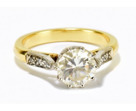 A yellow metal diamond solitaire ring, the brilliant cut diamond approximately weighing 1.5ct, with diamond chips to the shou