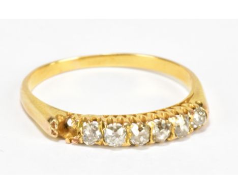 A yellow metal diamond ring, set with six diamonds and one missing (af), size M, approx 1.5g.