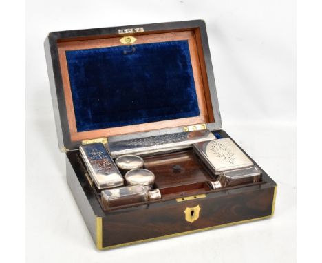 A Victorian brass bound rosewood gentleman's vanity box, the hinged cover lifts to enclose drop down mirror, tray of dressing