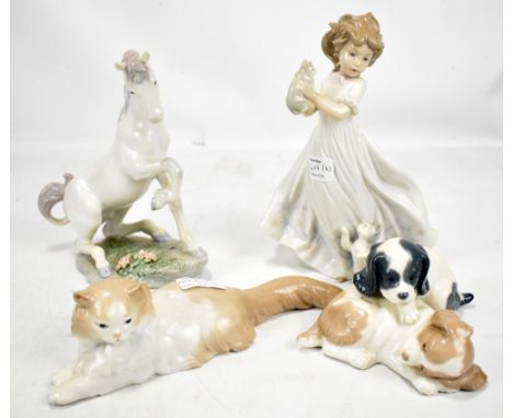 A Lladro porcelain figure of a unicorn, also two Nao figures of puppies and kittens (3).Additional InformationBoth ears have 