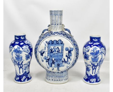 A large Chinese porcelain moon flask decorated in underglaze blue with men playing instruments to either side against floral 