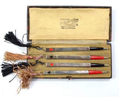 A cased set of four sterling silver mounted bridge pencils, the finials enamelled with playing card suits.