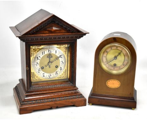 An early 20th century oak cased mantel clock of architectural form, having square face with circular dial set with Arabic num