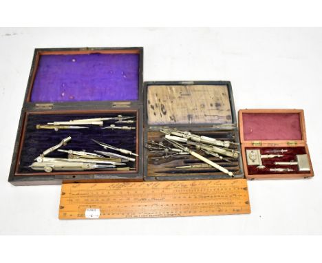 Three cased sets of drawing instruments, and a Thomlinson's Equivalent paper slide scale (4).