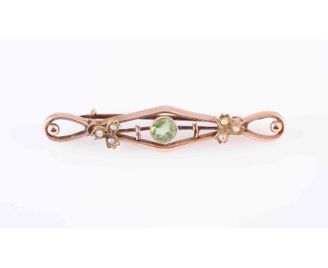A COLLECTION OF BROOCHES, to include A PERIDOT AND SEED PEARL BROOCH, the circular cut peridot collet set within a pierced mo