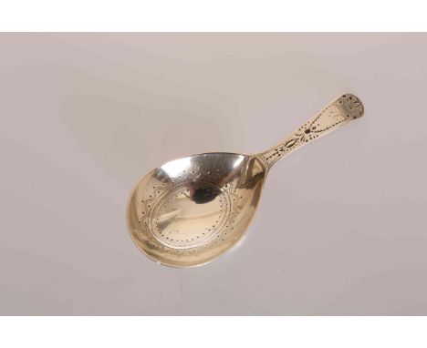 A GEORGE III SILVER CADDY SPOON, Thomas Wallis II, London 1802, with elongated oval bowl and bright-cut engraving. 9cm