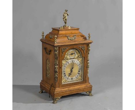 A WINTERHALDER & HOFMEIER OAK THREE-TRAIN BRACKET CLOCK, late 19th Century, the case with caddy top surmounted by a figure, t